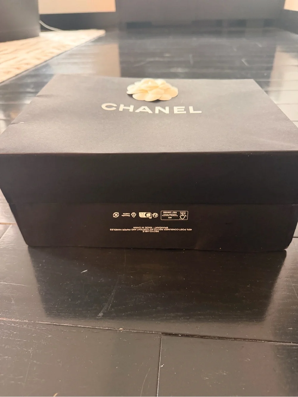 CHANEL Black bag (12” x 9”) with sticker flower accent